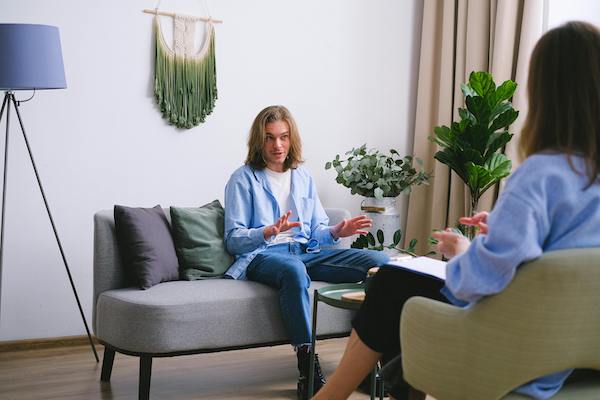 man talking to therapist in therapy session
