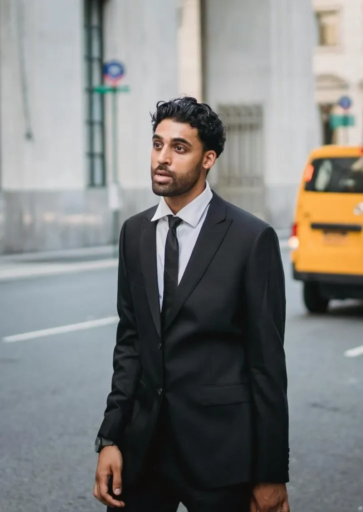 man in suit standing in street