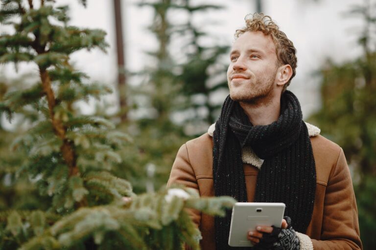 A Man With Scarf holding a Digital Tablet