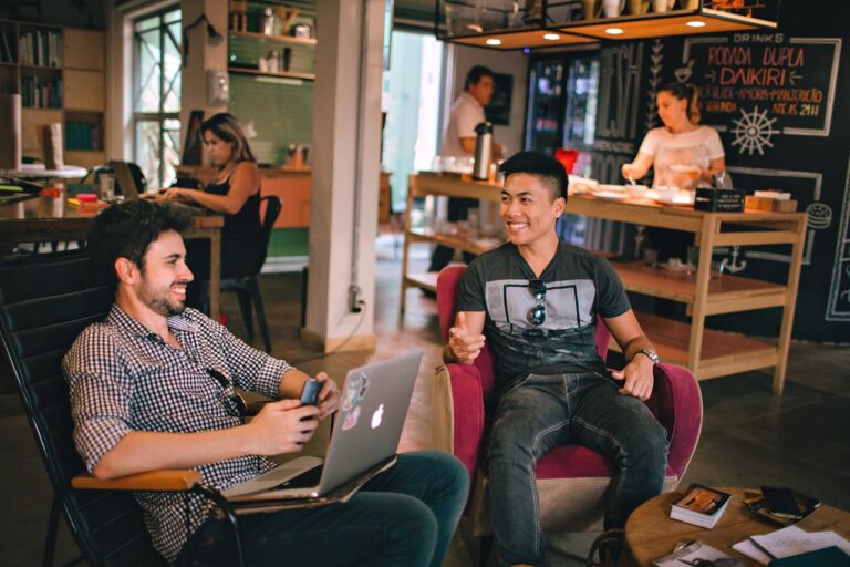 photograph-of-men-having-conversation-seating-on-chair