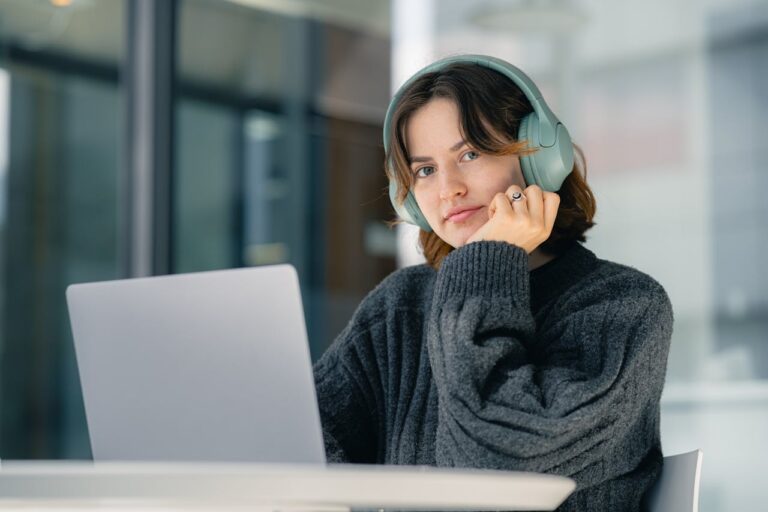 woman-in-headphones-working-on-laptop-indoors