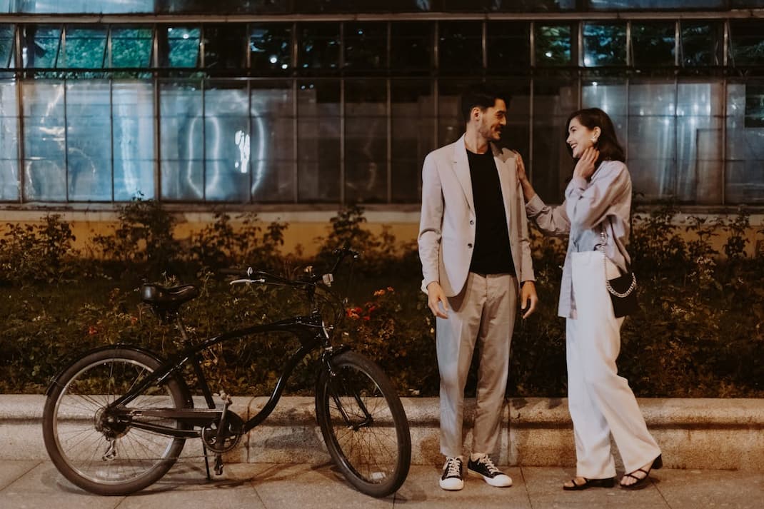 couple-in-business-attire-standing-on-pavement