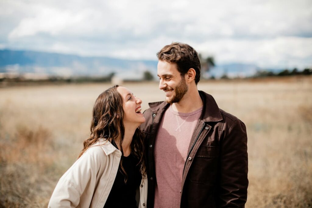 a-man-and-a-woman-standing-in-a-field