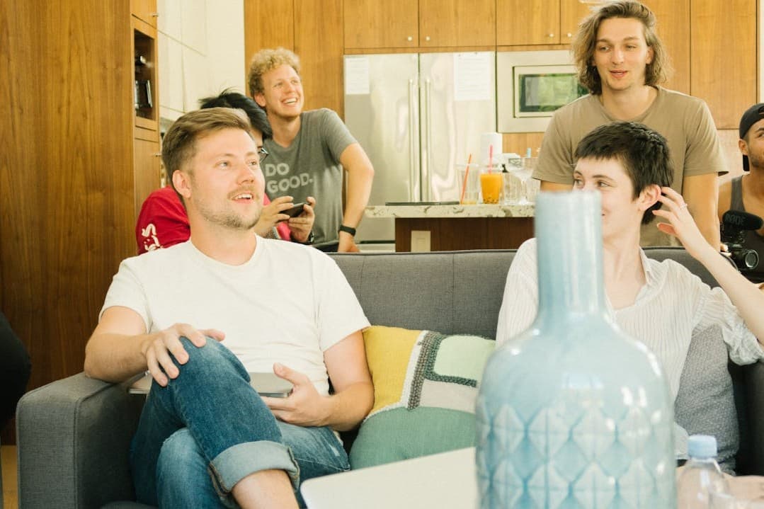 man-sitting-wearing-white-crew-neck-t-shirt-inside-room