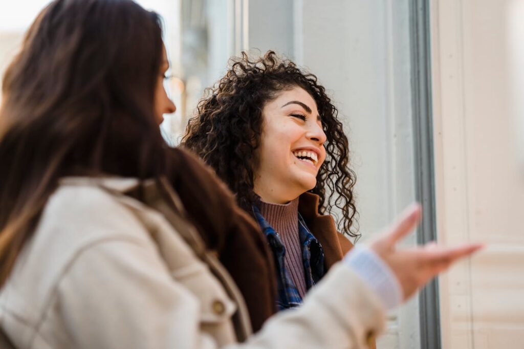 cheerful-young-diverse-ladies-laughing-on-street