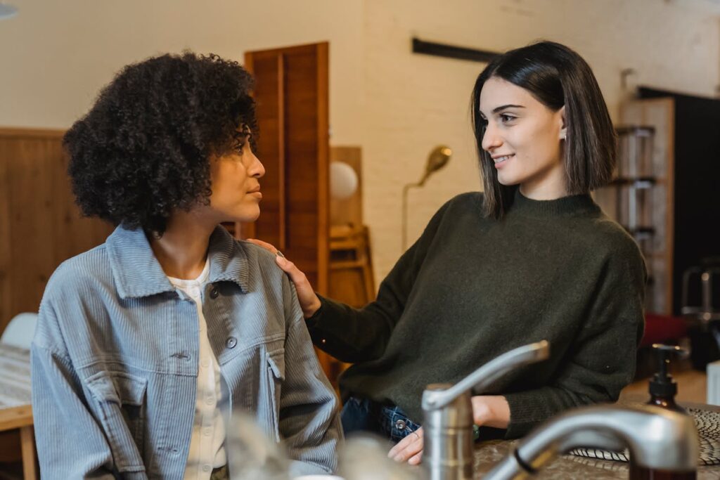 smiling-woman-comforting-black-upset-friend
