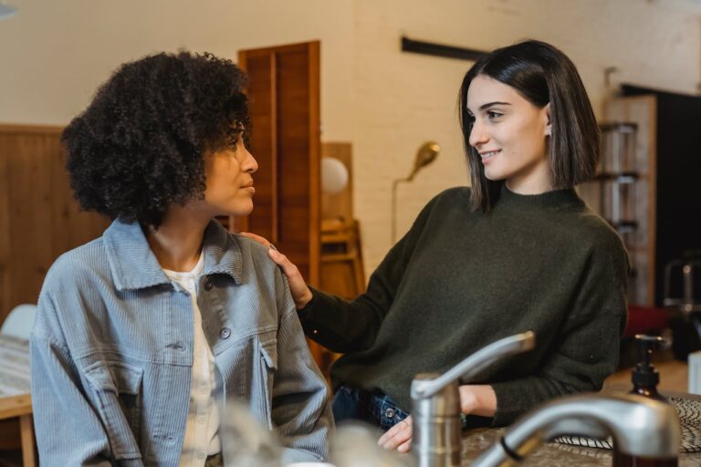 smiling-woman-comforting-black-upset-friend