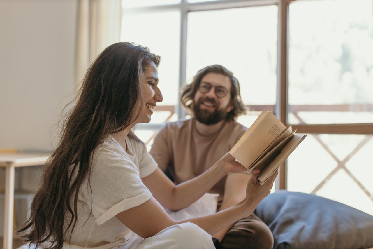 man-in-white-crew-neck-t-shirt-holding-book