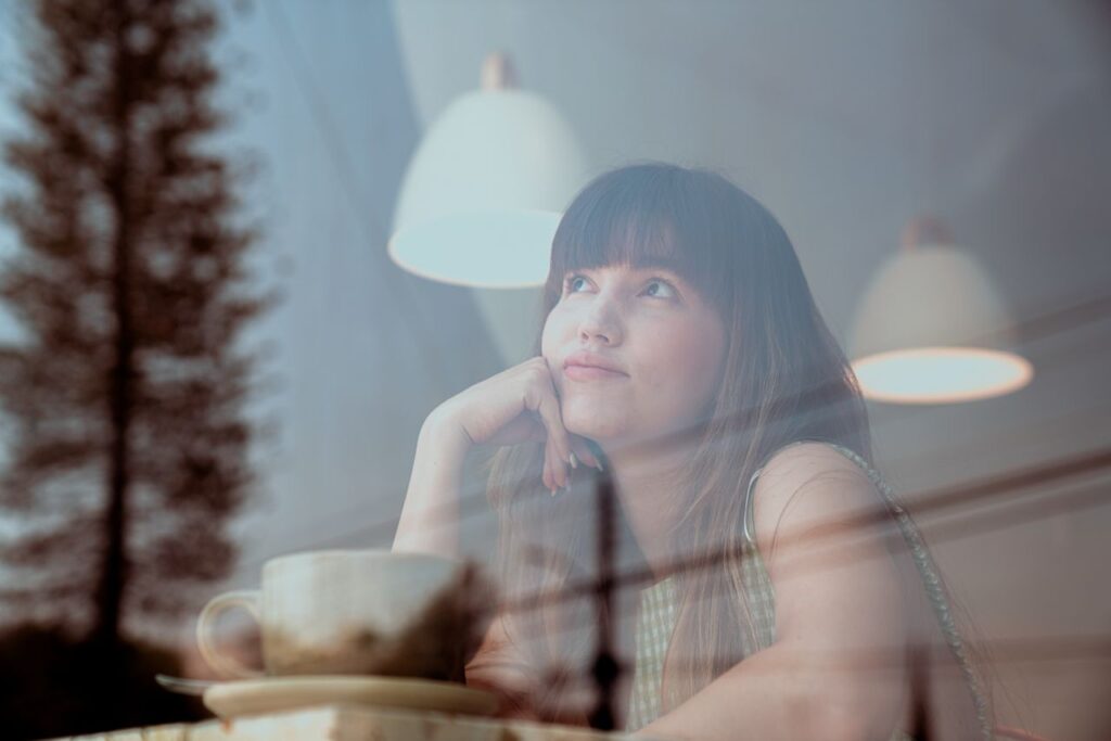 photo-of-an-attractive-woman-thinking-inside-a-coffee-shop