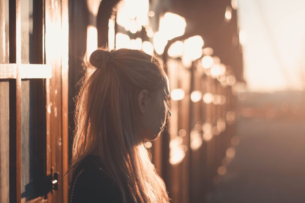 woman-standing-near-building-at-sunset