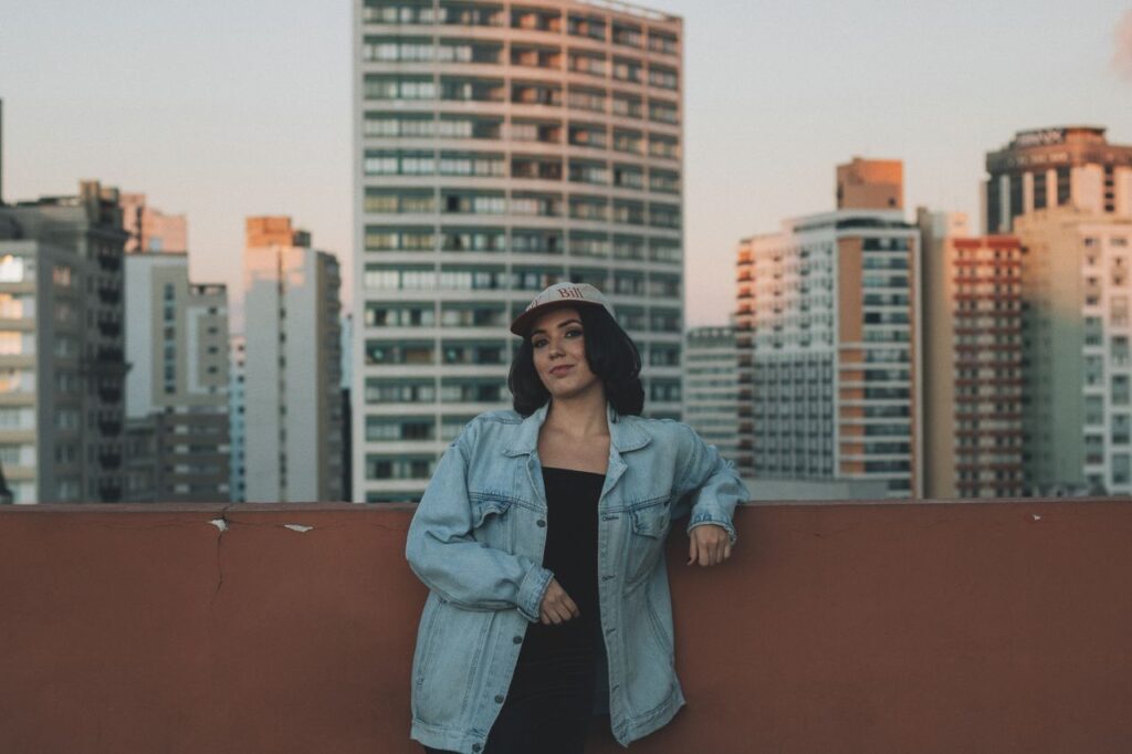 woman-in-denim-jacket-on-urban-rooftop-at-dusk