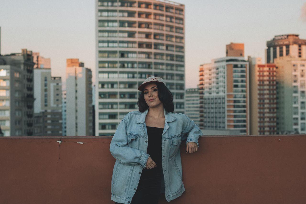 woman-in-denim-jacket-on-urban-rooftop-at-dusk