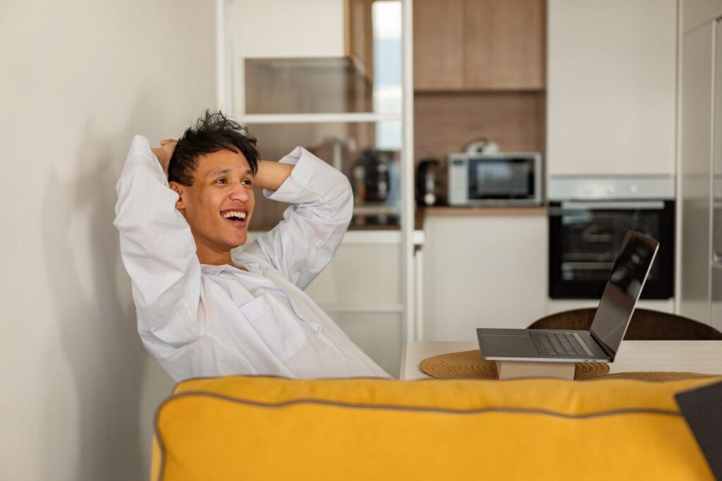 a-man-in-white-dress-shirt-sitting-at-a-table-with-laptop