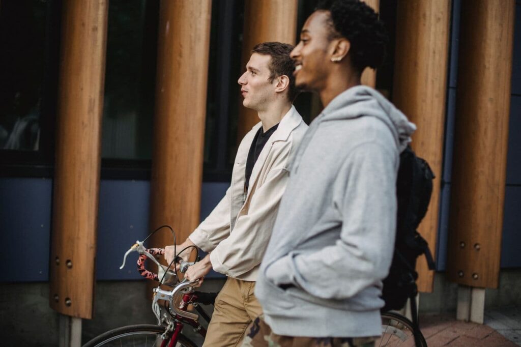 friends-with-bike-walking-on-street