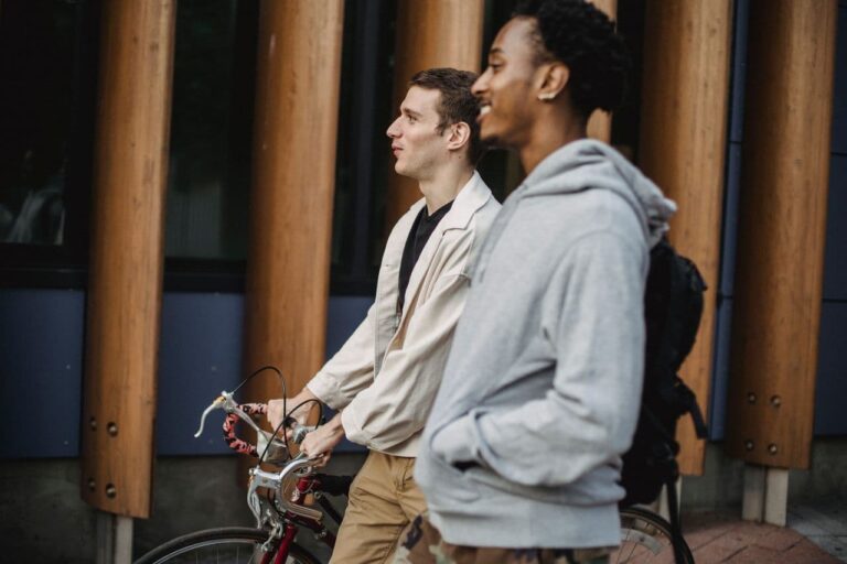 friends-with-bike-walking-on-street