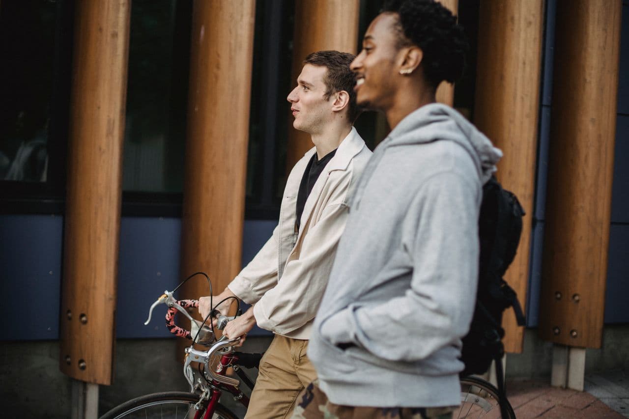 friends-with-bike-walking-on-street
