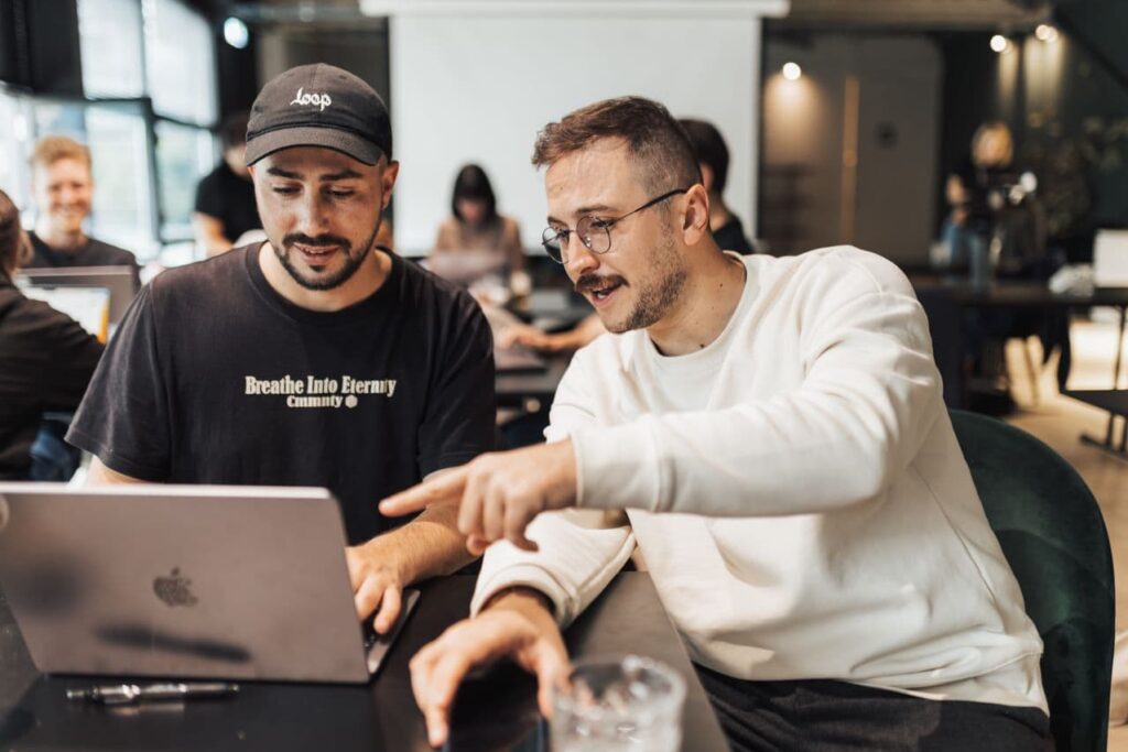 two-men-looking-at-a-laptop