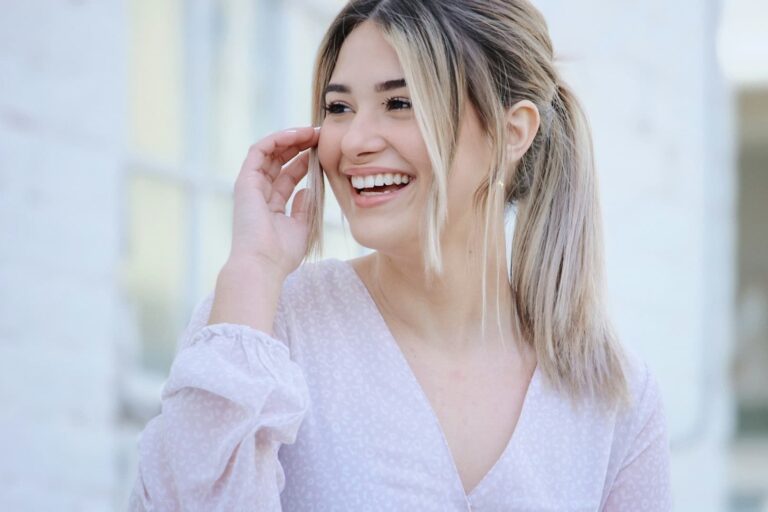 woman-in-white-v-neck-long-sleeve-shirt-smiling