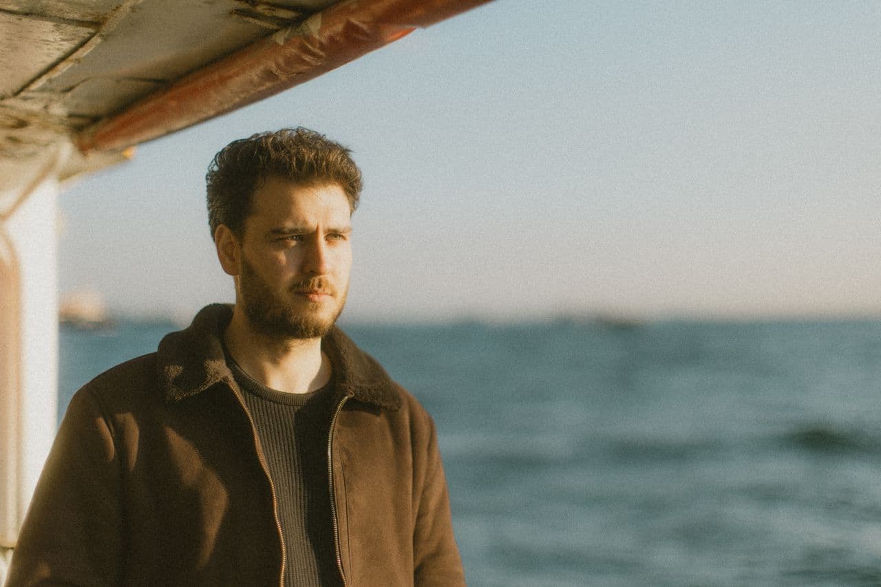 pensive-man-on-a-boat-in-istanbul-at-sunset