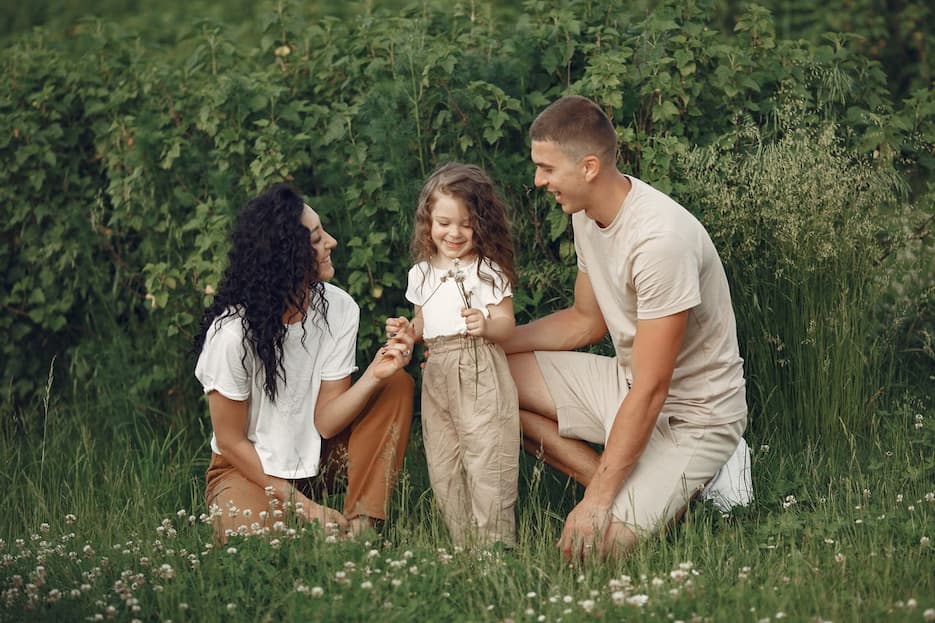 family-on-field-picking-up-flowers