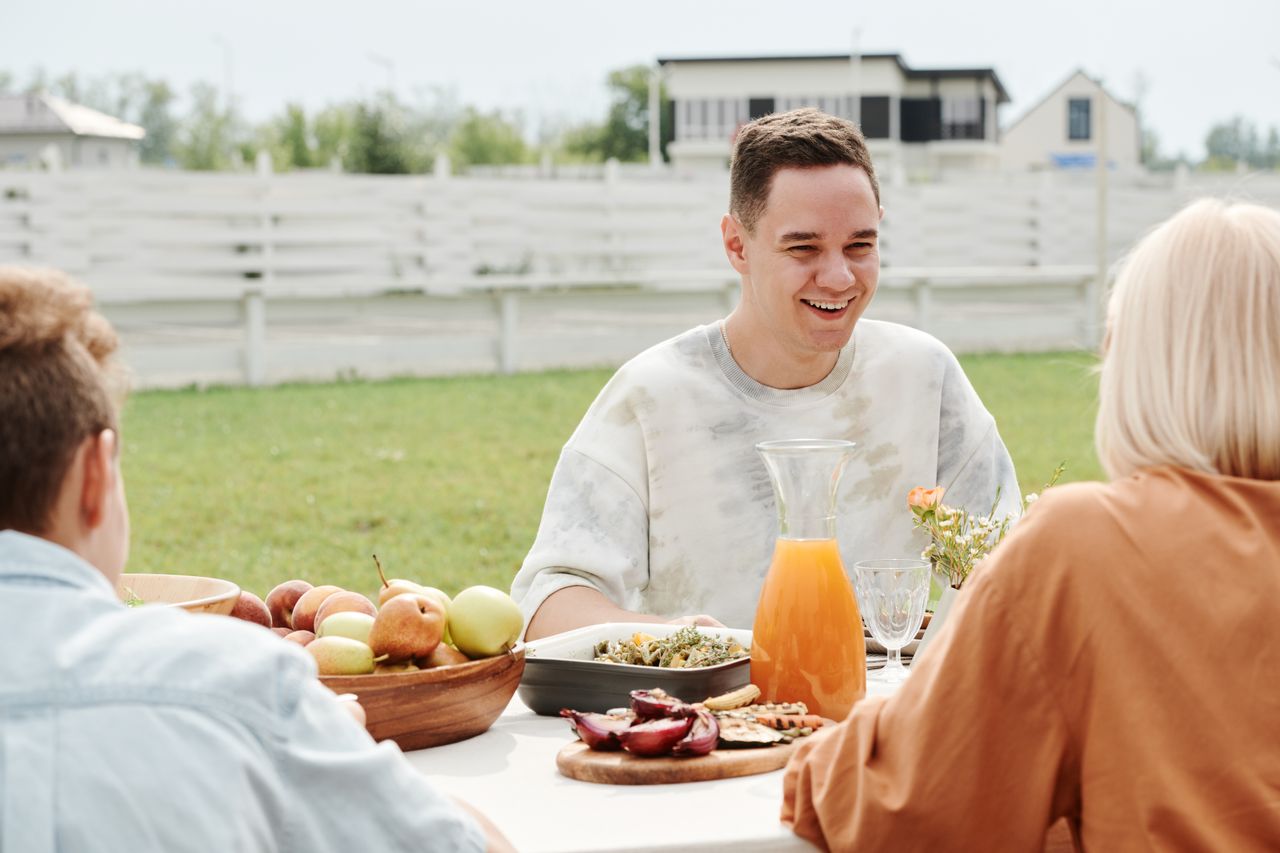 a-man-smiling-while-talking-his-mother